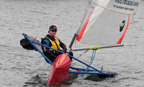 Danon Ware sails his Moth class dinghy towards the start line. Danon Ware sails his Moth class dinghy towards the start line.